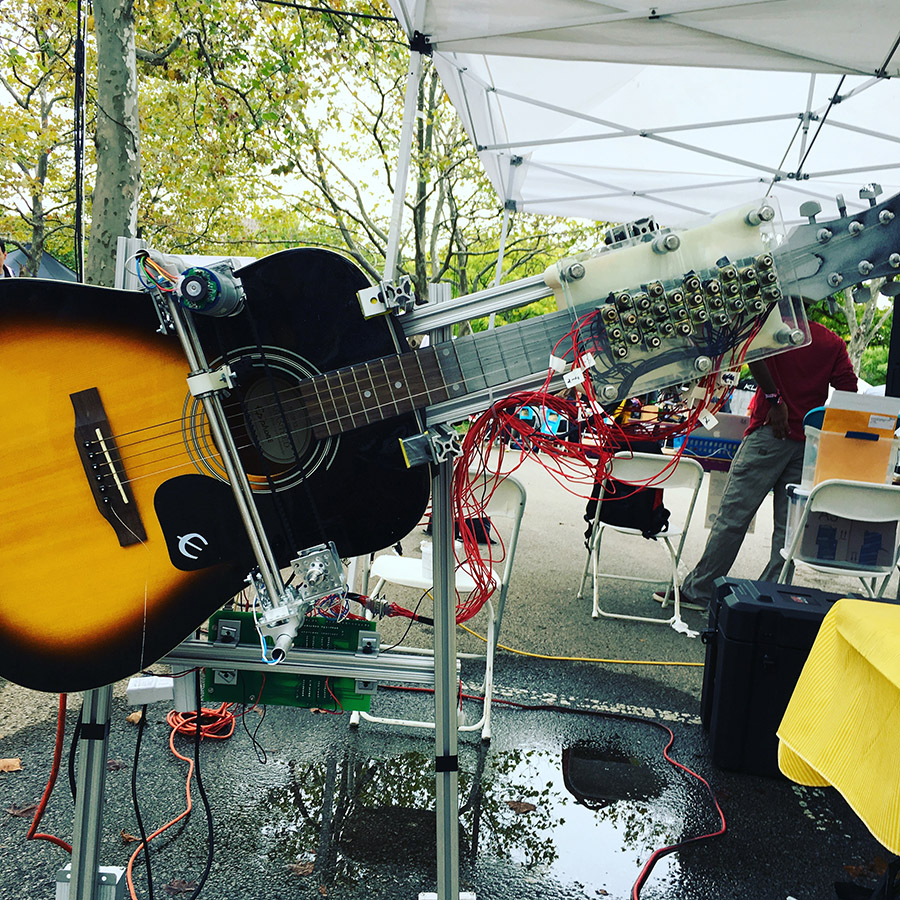 Robotic guitar playing machine